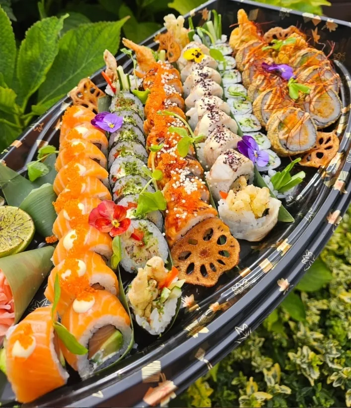 Family Platter: rows of salmon and tobiko rolls, cucumber maki, spicy rolls, avocado rolls and crispy katsu rolls with lotus crisps and lime